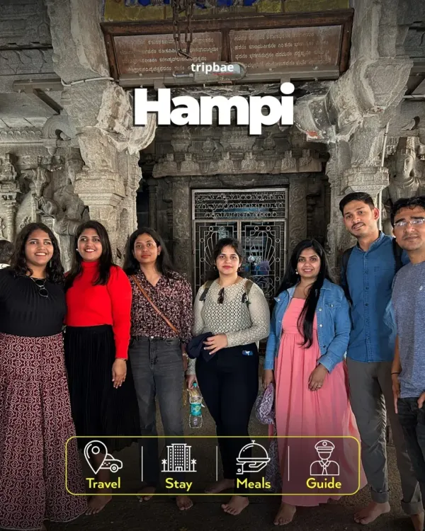 A group of travelers inside one of Hampi's magnificent stone temples. Our all-inclusive trips make exploring this vast historical site easy and fun.