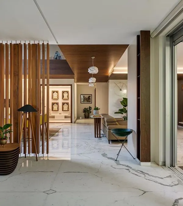 In the Kanasu residence, large sliding glass doors completely retract, merging the living room with the outdoor deck and vertical garden. This creates a single, expansive space for relaxation and entertainment.
