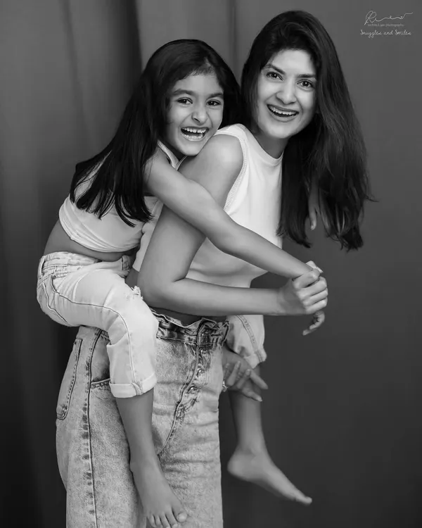 This is the magic I live for. The pure, unscripted joy between a mother and her daughter, captured in a timeless black and white portrait that you'll cherish forever.
