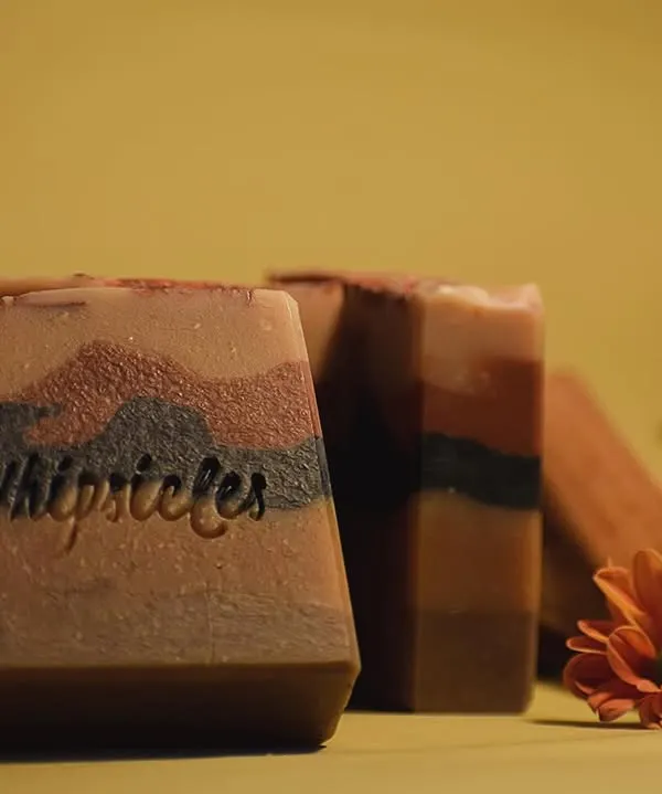 Our 5-layered Sandalwood soap, the grand finale of our Diwali collection. It's crafted to elevate your 'pahili anghol' with layers of activated charcoal, turmeric, and various natural clays.
