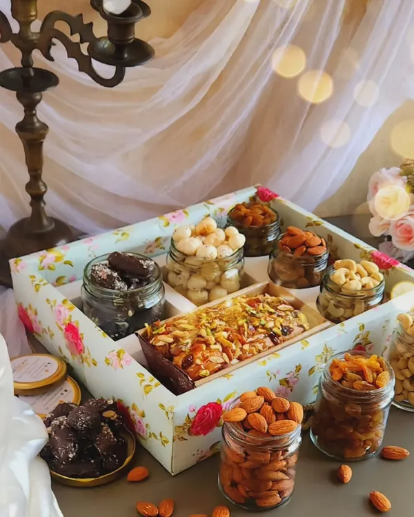 Our Lavish Tea Time Hamper is designed to impress. It features a beautiful floral tray filled with our signature tea cake, assorted premium nuts, and rich chocolate treats, making it a perfect gift for valued clients.