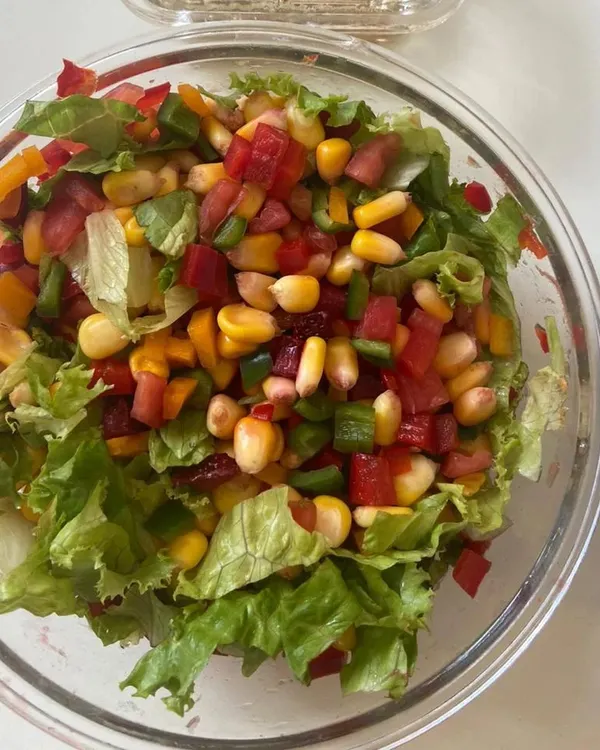 Our chopped vegetable salad is a rainbow in a bowl. It's loaded with fresh lettuce, sweet corn, and colorful bell peppers for a crunchy, light, and healthy meal.