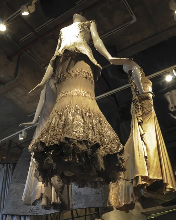 Mannequins displaying haute couture gowns appear to float within the Gaurav Gupta store. This low-angle shot emphasizes the verticality of the space and the way the sculpted interior directs the eye, turning fashion into a form of installation art.