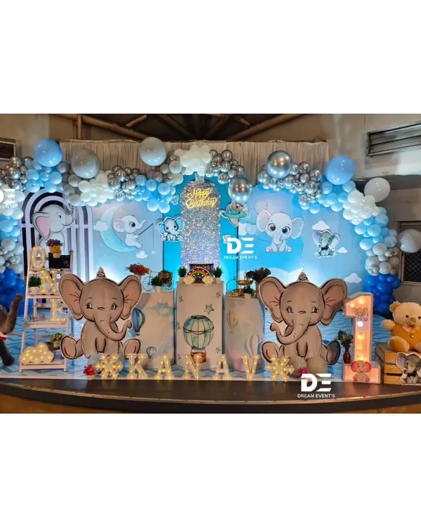 A dreamy baby elephant theme for a first birthday. I used a soft blue and silver color palette, cloud-like props, and cute elephant cutouts to create this magical sky-themed stage.