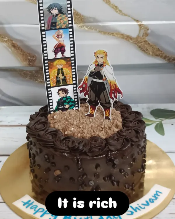 A chocolate chip cake for a "Demon Slayer" fan. This design features an edible film strip of characters and a cutout of the fan-favorite, Rengoku.