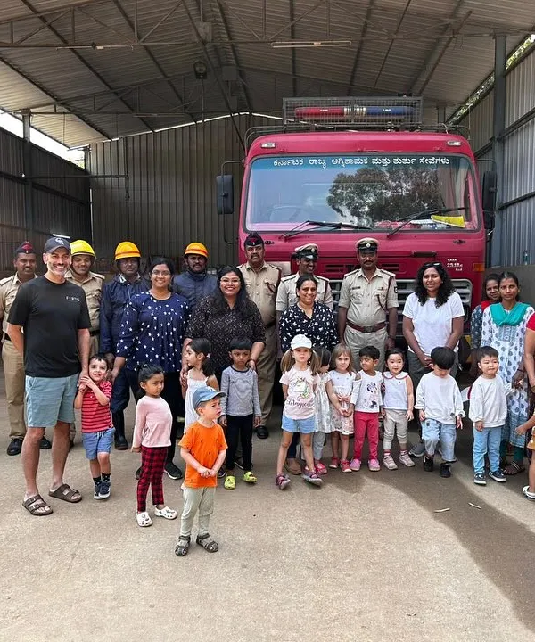 A proud moment for our campers and their families, posing with the firefighters at the local fire station. Field trips like this help children understand the important roles people play in our community.