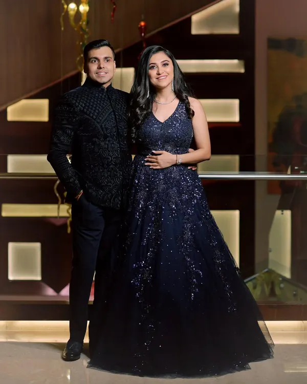 A classic engagement portrait of a couple, perfectly coordinated in their stunning blue and black outfits. We ensure that even posed shots feel natural and reflect your connection.