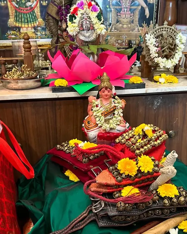 Our altar for the Dussehra Puja. We offer our salangai (ankle bells) and instruments to the goddess Saraswati, seeking her blessings for our learning journey. This ritual of Vidyaarambham marks the beginning of a new year of dance education.