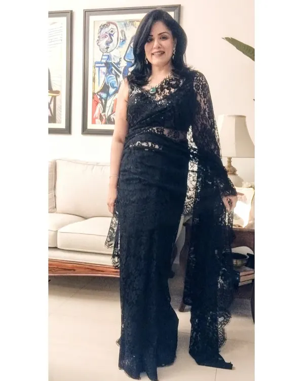 For a milestone birthday party, a black Chantilly lace saree felt just right. It's a sophisticated and timeless choice for an evening of celebration.