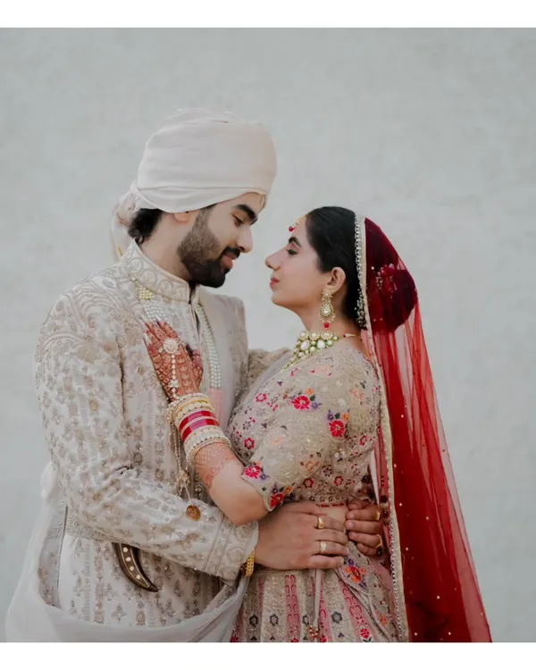 A perfect example of a cinematic portrait. The couple is lost in each other's eyes, creating an intimate and timeless image against a simple, clean background.