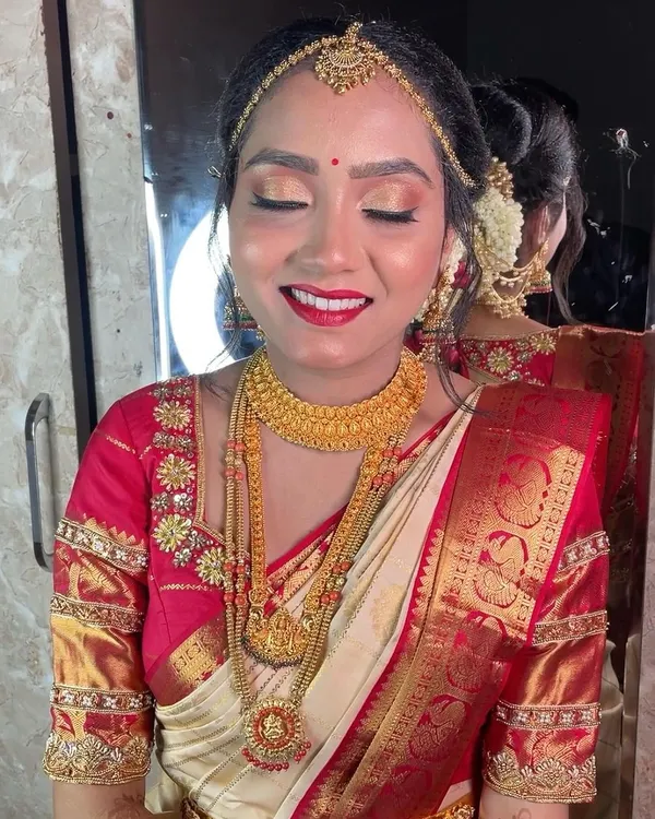 This is the joy I love to capture. For this bride's Muhurtham, we went for a classic look with radiant skin, a bold red lip, and eyes that sparkle, all complementing her beautiful gold temple jewellery.