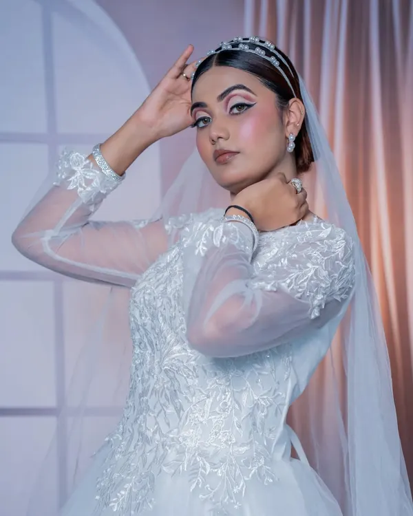 A beautiful Christian bridal look featuring a classic white gown, elegant veil, and a pearl headband.