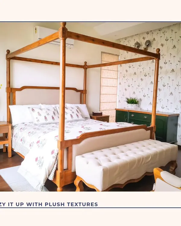 A classic four-poster bed brings a touch of timeless elegance to this bedroom. Paired with a delicate botanical wallpaper and a plush bench, this space is designed to be a cozy and luxurious retreat.