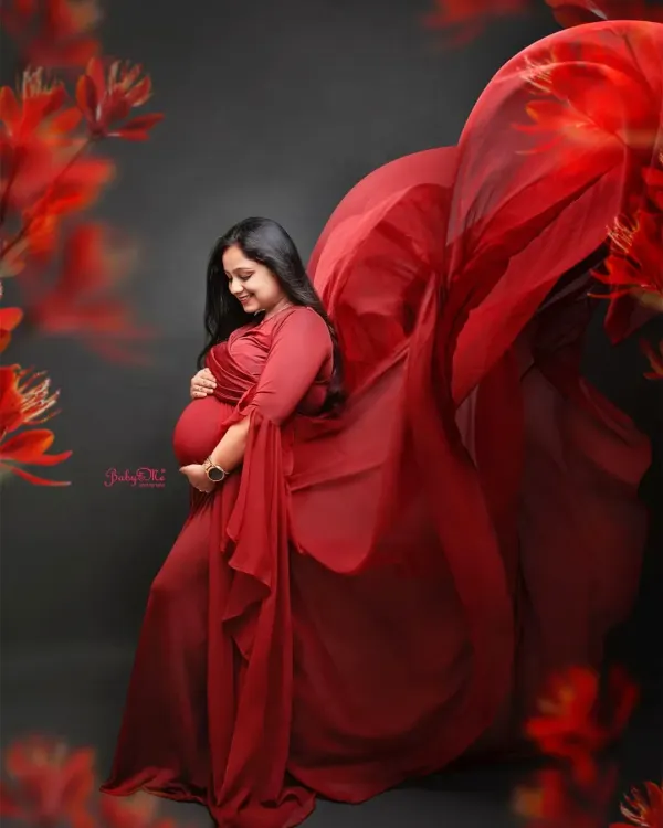 I love a dramatic fabric toss! This gorgeous mama in a deep red gown looks absolutely magical. This technique adds so much movement and life to a maternity portrait.