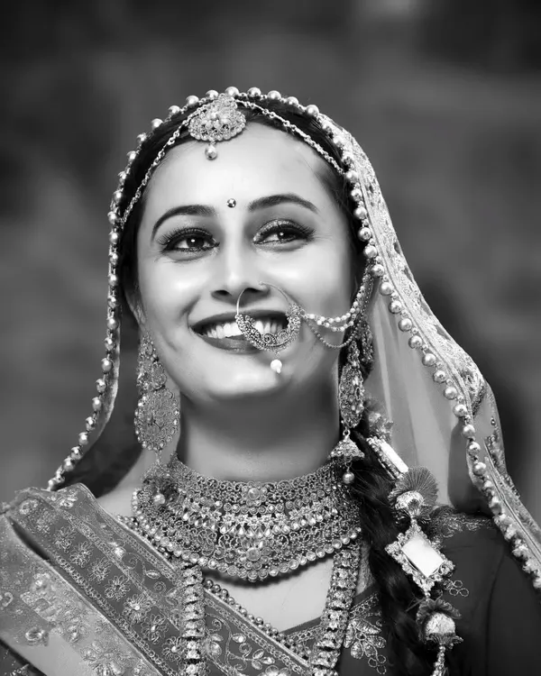 A joyful black and white portrait of a bride. Without color, her bright smile and sparkling eyes become the absolute focus of the image.