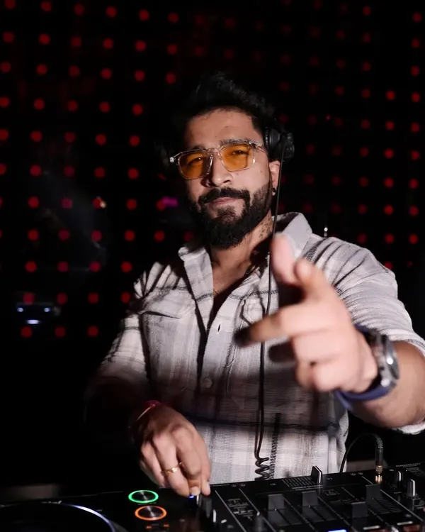 Pointing to the crowd, ready to drop the next beat. This is me in my element, connecting with the audience from behind the console.