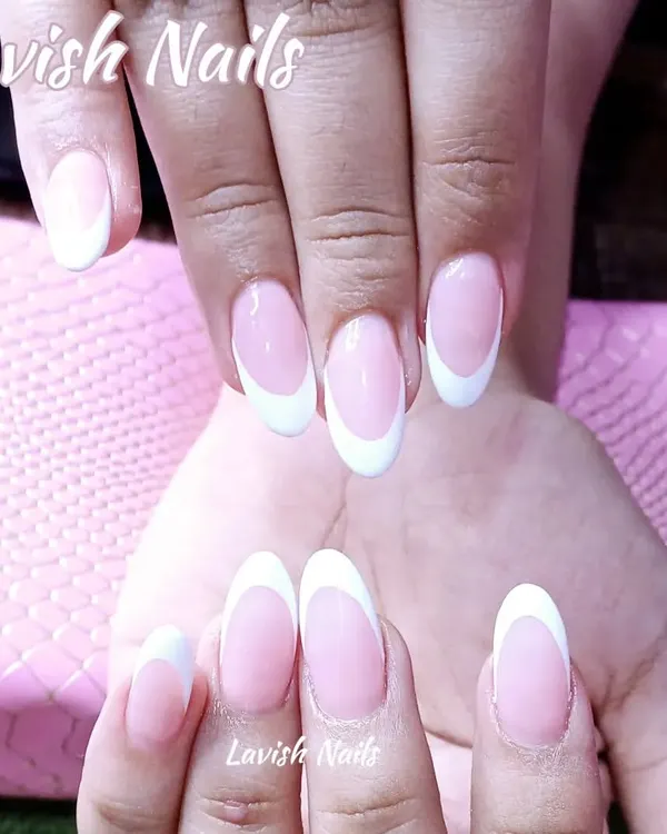 The quintessential classic French manicure on perfectly shaped oval nails, offering a clean, elegant, and timeless bridal look.