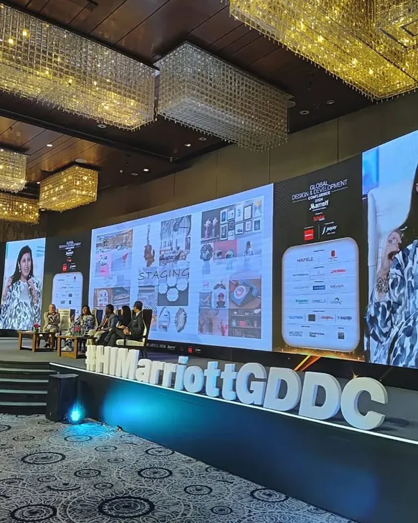A shot of our director on the big screen during the panel discussion at the Marriott Global Design & Development Confluence 2024.