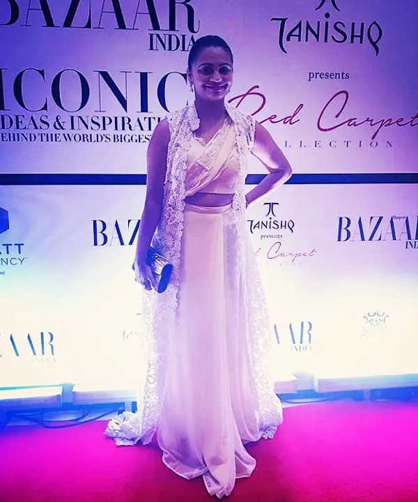 It was a pleasure to design this outfit for a client attending a Harper's Bazaar red carpet event. This elegant white ensemble features a crop top, flowing skirt, and a long, sheer lace jacket.