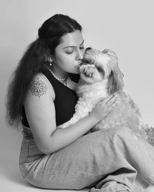 A sweet kiss for a beloved pet. Black and white photography beautifully emphasizes the emotional connection and tenderness in moments like this, creating a timeless piece of art.
