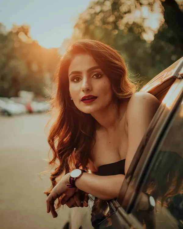 Using a car as a prop for a cinematic, golden-hour portrait. This style is perfect for capturing a candid, story-driven moment that feels like a still from a movie.