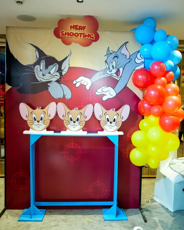 A custom-made Nerf shooting gallery for a Tom & Jerry party, where guests can aim for Jerry-themed targets.