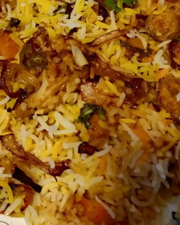 A close-up of my Veg Dum Biryani, slow-cooked to perfection. You can see the layers of long-grain basmati rice, mixed vegetables, and crispy fried onions.