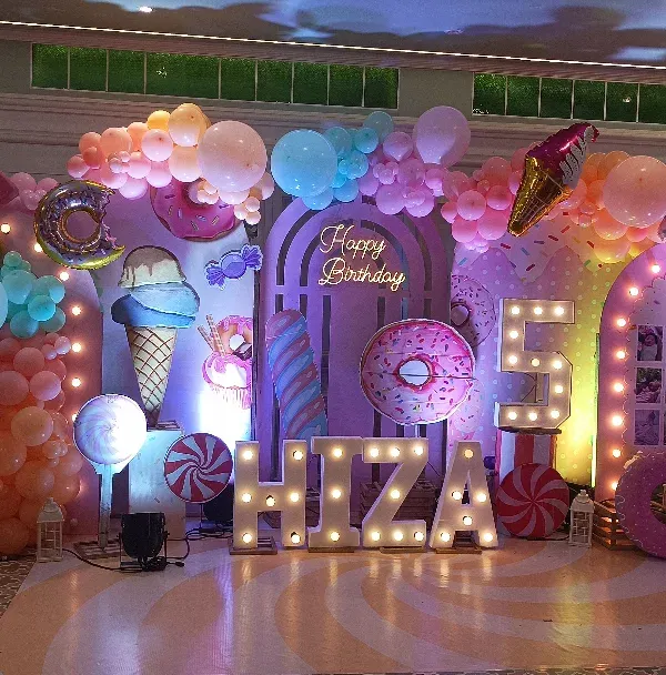 This is what a full-scale Candyland dream looks like! I love creating these huge, immersive backdrops with giant candy props, custom marquee letters for the name and age, and tons of colorful balloons. It's a super popular theme that makes any kid's birthday party feel magical.