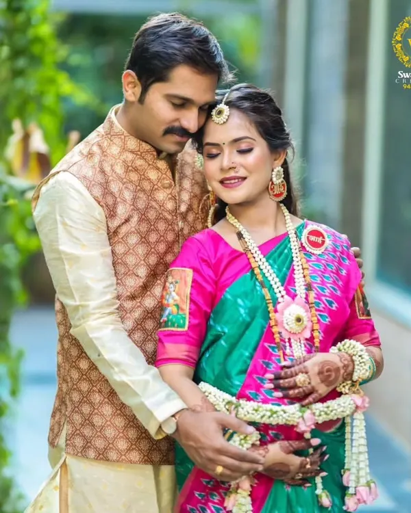 A beautiful moment between the parents-to-be. The expectant mother is wearing a full set of my handcrafted baby shower jewellery, including a delicate kamarpatta.