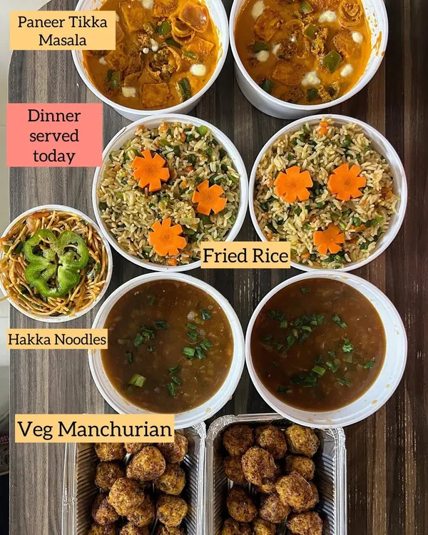 A complete Indo-Chinese dinner spread, featuring Veg Manchurian, Hakka Noodles, Fried Rice, and Paneer Tikka Masala for a fusion touch.