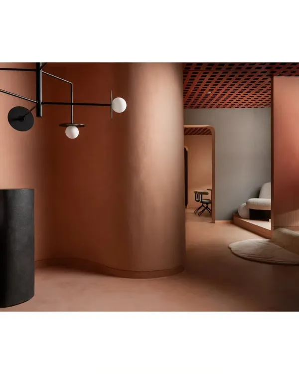 The layout flows with soft, curved walls, guiding visitors through different lighting vignettes. This design choice eliminates harsh corners and creates a more gentle, exploratory journey through the retail space.