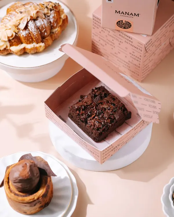 We love dessert photography projects! This shot features a rich brownie, a delicate almond croissant, and a chocolate cinnamon roll. The bright, airy styling makes the whole spread look fresh and irresistible.