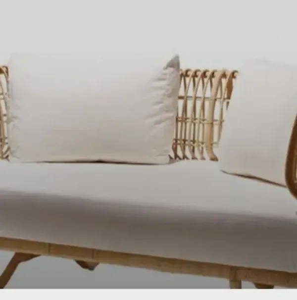 Our two-seater rattan sofa combines a modern, minimalist frame with traditional weaving techniques. It's a lightweight yet durable piece, perfect for compact living spaces, office lounges, or boutique hotel rooms, complete with comfortable, high-quality cushions.