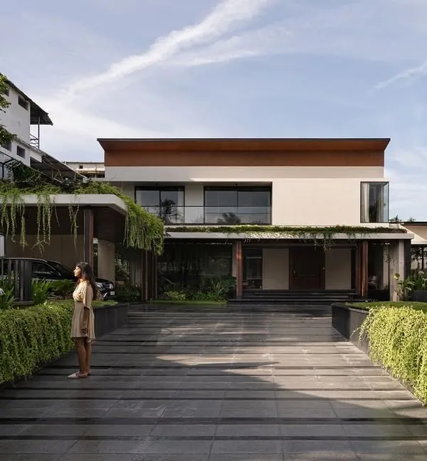 The exterior of Villa Shakthi in Cherpu, Kerala, is defined by a central pool court that anchors the entire design. The home is spread across a 2,500 sqm site, with rooms and circulation oriented to overlook this tropical oasis, creating a constant connection between the indoors and the lush landscape.