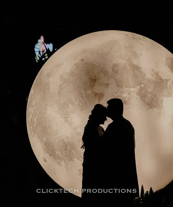 A romantic silhouette of a couple against a stunning moon backdrop. This is the kind of magical, cinematic shot I love to create for pre-wedding photoshoots.