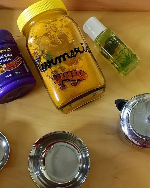 The simple household ingredients for our "invisible ink" experiment: turmeric, baking soda, and lemon juice. I show the children how everyday items can create scientific magic.