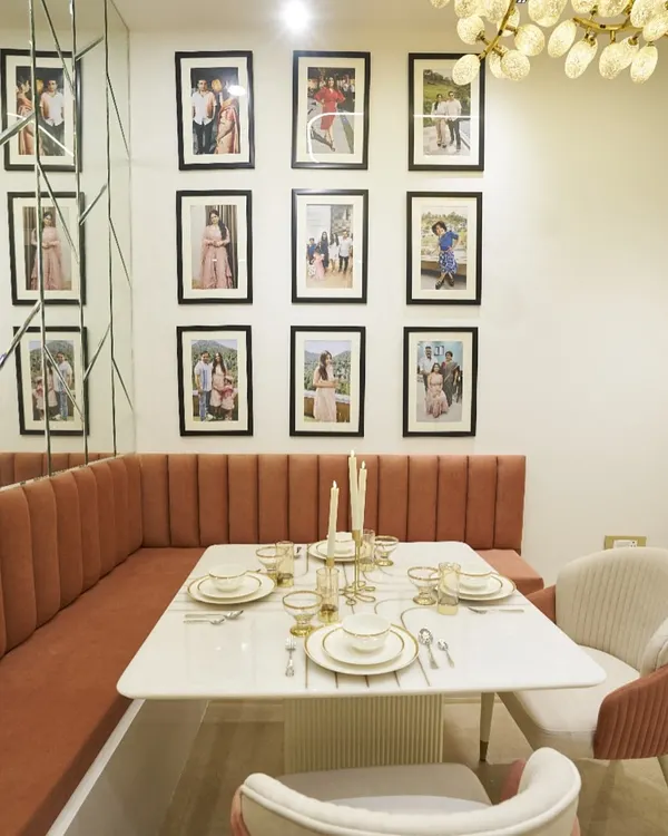 Designed for dinners, remembered for moments. This cozy dining nook features comfortable banquette seating and a gallery wall for family photos.