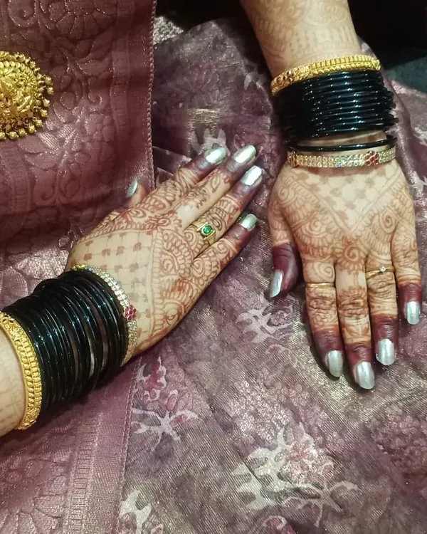 A beautiful shot of the developed henna stain, complemented by traditional black bangles. The deep color shows the quality of the organic paste I use.