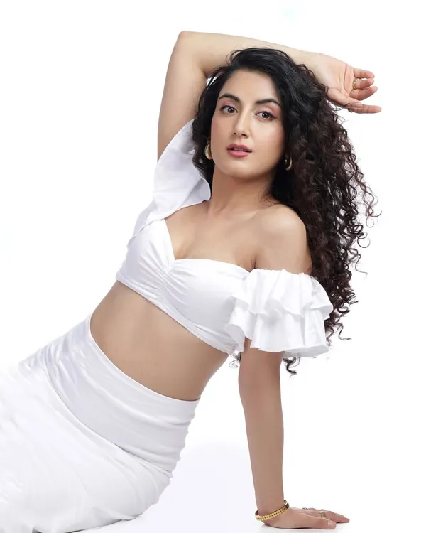 A clean, high-key studio shot in all white. This type of image is perfect for a portfolio, showcasing the model's form and features with bright, even lighting.