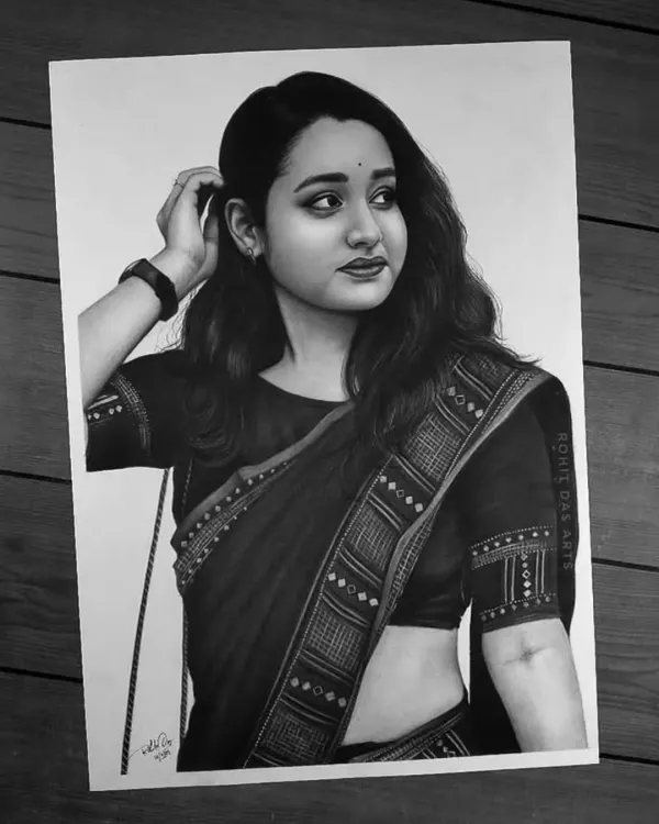 This is a completed commission piece, drawn with graphite and charcoal. I focus on capturing the fine details, from the expression to the intricate patterns of the saree, to create a portrait that feels truly alive.