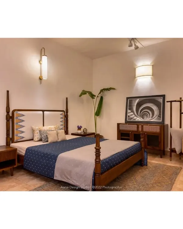 A complete bedroom setting at our studio, featuring the Maadhya bed with its distinctive headboard, the Soiree bedside table, the Sirutha console, and the Makam clothes rack. This demonstrates how we can furnish an entire bedroom with coordinated pieces.