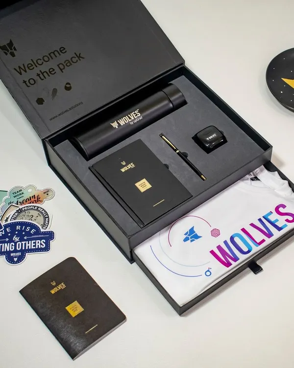 This is the kind of first impression that builds loyalty. We designed this premium "Welcome to the Pack" onboarding kit for Wolves, featuring a custom t-shirt in a pull-out tray, a sleek branded bottle, a notebook, pen, stickers, and other essentials, all presented in a high-quality magnetic box.