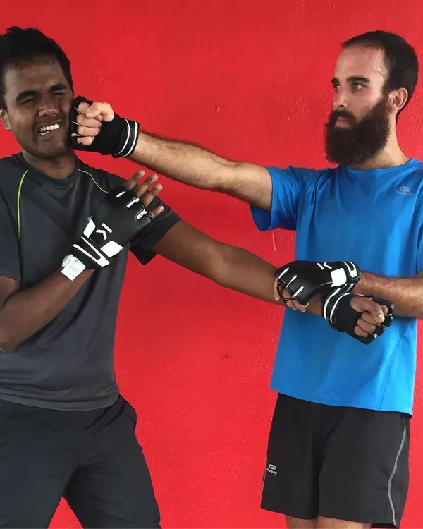 Students engage in a sparring drill wearing protective gloves. This practice helps build timing, reflexes, and the confidence to use Wing Chun techniques under pressure.