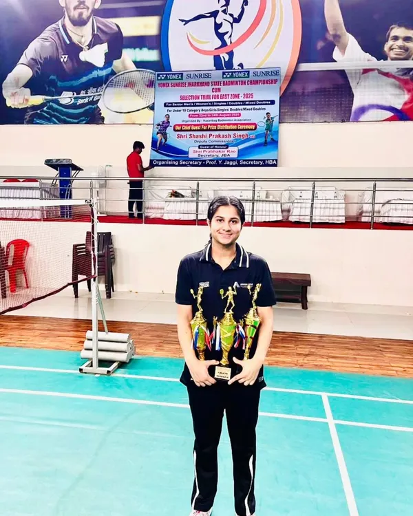 The rewards of dedication. One of my star players, Sara, showcasing her multiple trophies from the Jharkhand State Championship. Her victories in singles and mixed doubles are a testament to her versatile skill set.