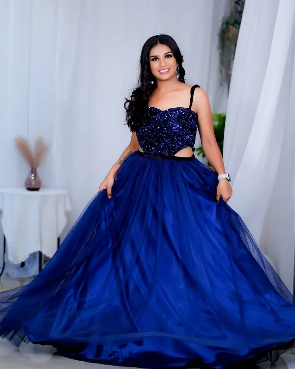 A full-length shot of a glamorous party look. I created a bold eye and styled the hair in loose waves to match the drama of this stunning sequined blue gown.