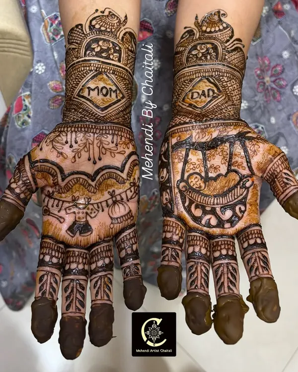 A special design for a special occasion. This baby shower mehendi features "Mom" and "Dad" on the wrists, with a baby in a cradle on one palm and other cute baby-related motifs.