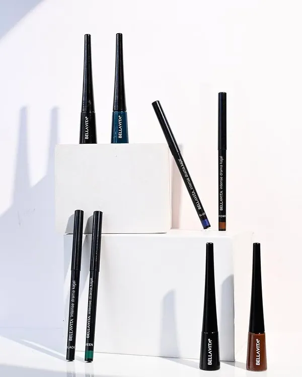 A vibrant and dynamic product shot for Bella Vita eyeliners. The use of white blocks for staging creates a clean, geometric composition, while the arrangement shows off the full range of colors available.