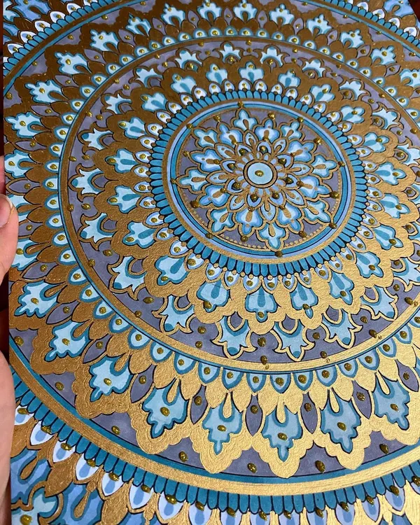 This intricate mandala, detailed with shades of blue and shimmering gold paint, is one of my favorite creations. I use high-quality acrylic sheets to ensure the colors are vibrant and the details are crisp, making it a perfect statement piece for any room.