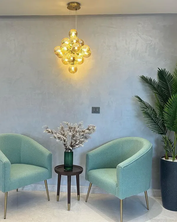 A happy client's space featuring our clustered glass globe pendant. It adds a beautiful, warm touch to their seating area. Seeing our lights in real homes is the best part of my job.