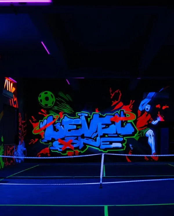 This is Mumbai’s first glow-in-the-dark mural on a pickleball court, a project for Level One Arena. I used special UV paints to create a dynamic, high-energy space that completely transforms under blacklight, perfect for an immersive gaming and sports experience.